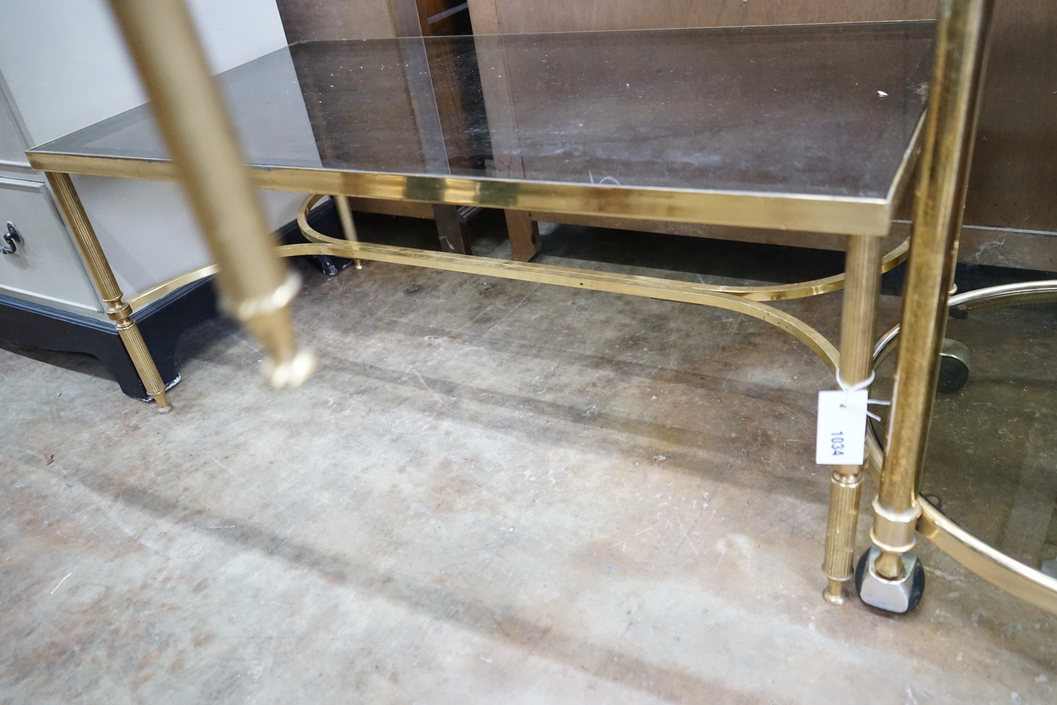 A brass and smoked glass rectangular coffee table, width 99cm, depth 51cm, height 42cm
